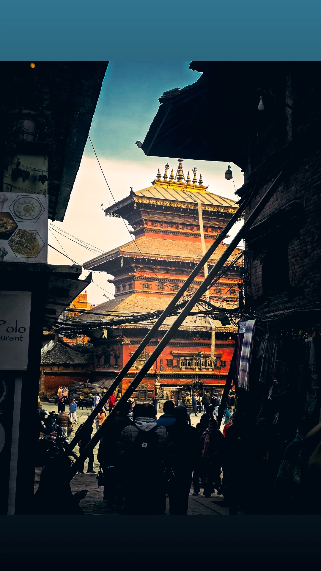 Golden temple framed by an old Kathmandu alleyway